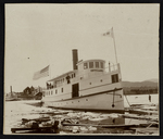 [Ferry boat breaking through ice and logs] by Unknown