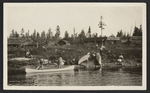 Canoes at a logging camp by Unknown