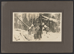 Family in front of their cabin by Clarence W. Meade