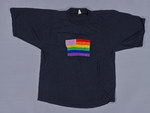 [Embroidered rainbow flag with a white square in the top left corner with pink hearts in it]