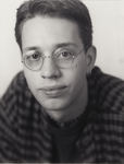 Person wearing plaid shirt and glasses