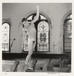 Nude man standing on church pew
